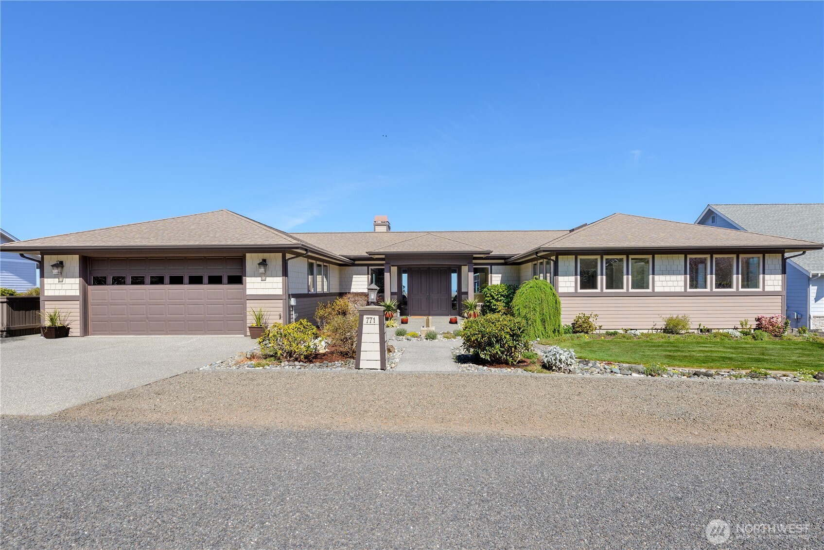 771 Brigadoon Boulevard Sequim, WA 98382 - Photo 4 of 40 a front view of a house with a garden and balcony