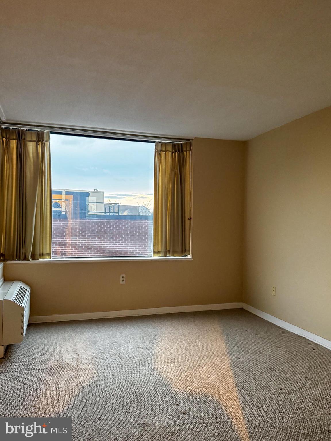 2141 P Street Northwest, Unit 705 Washington, DC 20037 - Photo 10 of 22 a view of an empty room with a window