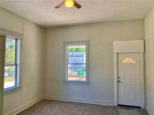 a bathroom with a tub a toilet and a mirror