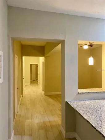 a view of a bathroom with a granite countertop sink and a mirror