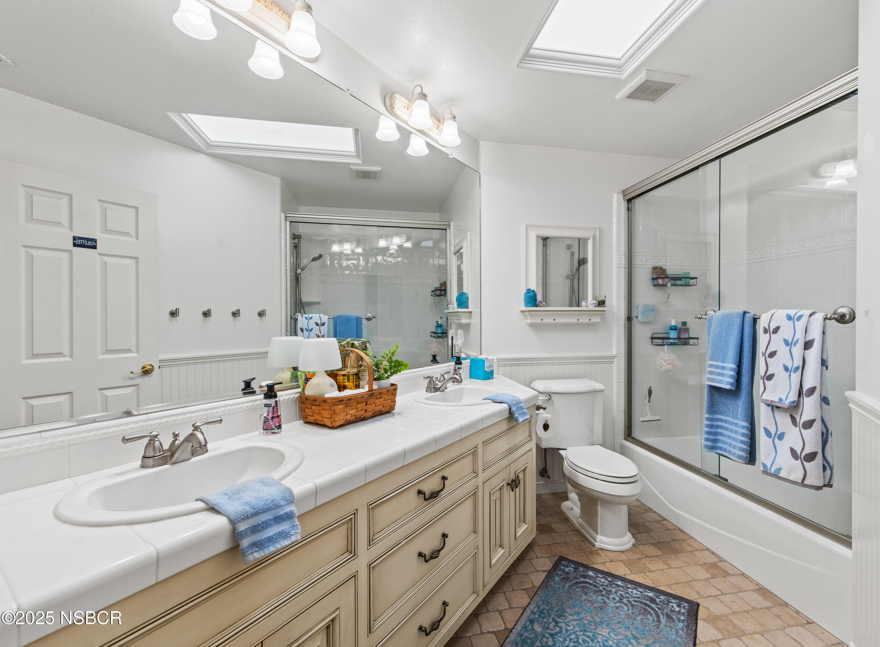 922 College Canyon Road Solvang, CA 93463 - Photo 13 of 23 a bathroom with a granite countertop sink mirror vanity and toilet