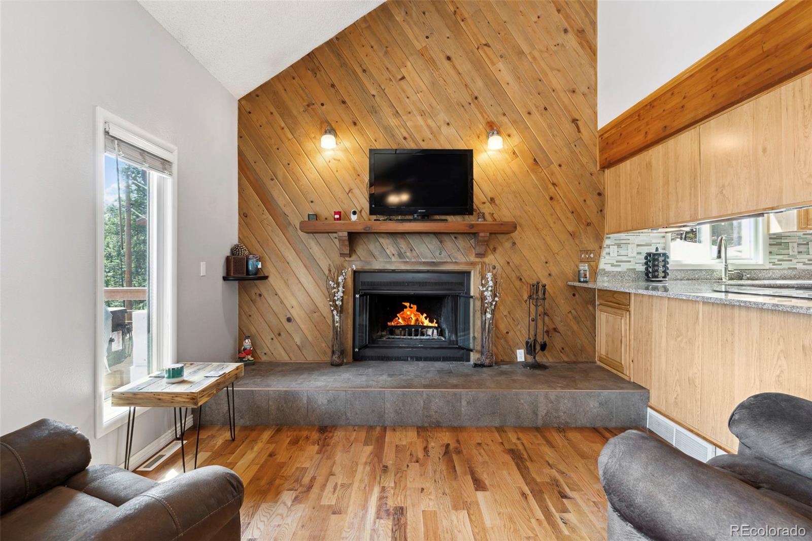 10807 Timothys Drive Conifer, CO 80433 - Photo 16 of 39 a living room with furniture and a fireplace