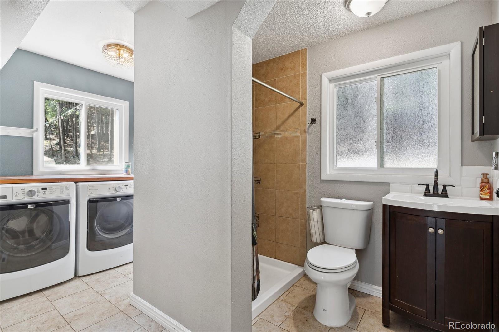 10807 Timothys Drive Conifer, CO 80433 - Photo 20 of 39 a bathroom with a sink a toilet and a mirror