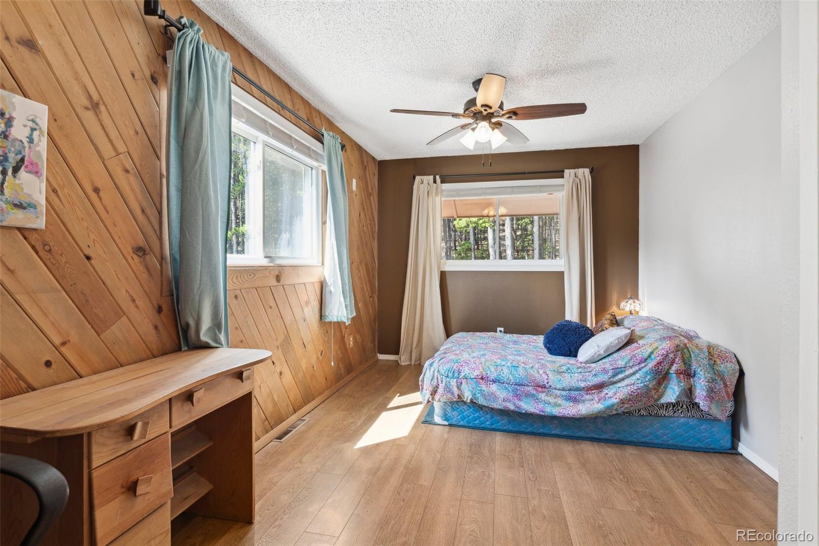 10807 Timothys Drive Conifer, CO 80433 - Photo 22 of 39 a bedroom with a bed and a window