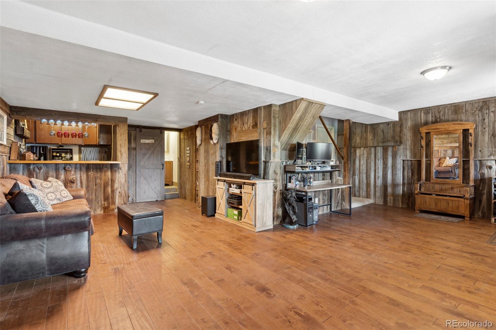 10807 Timothys Drive Conifer, CO 80433 - Photo 26 of 39 a living room with furniture and a flat screen tv