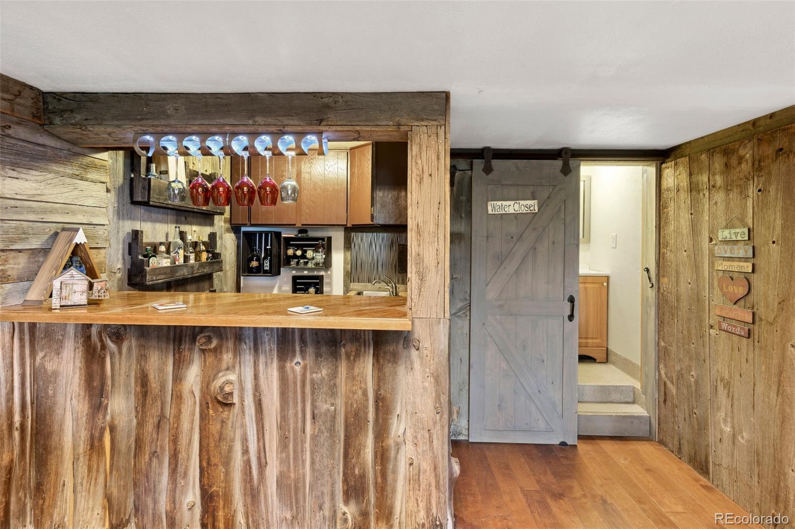10807 Timothys Drive Conifer, CO 80433 - Photo 30 of 39 a kitchen with a refrigerator and wooden cabinets