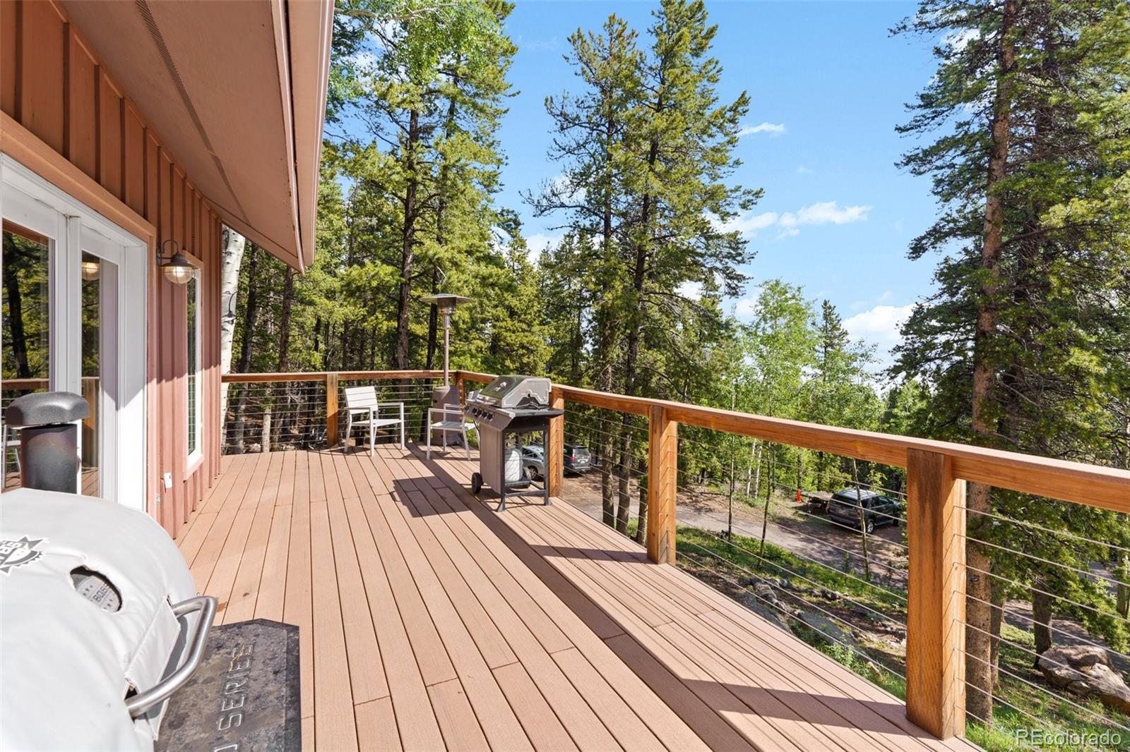 10807 Timothys Drive Conifer, CO 80433 - Photo 8 of 39 a view of balcony with wooden floor and fence