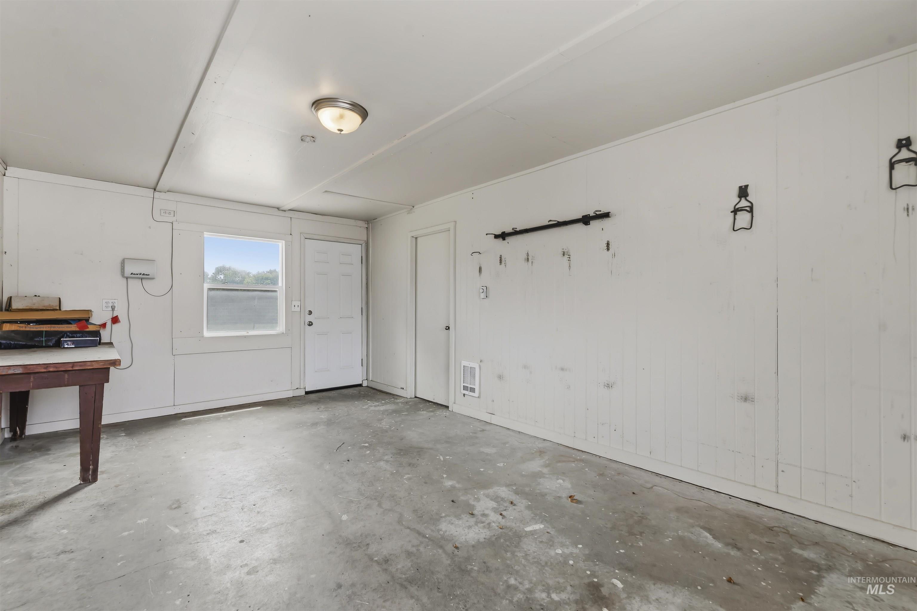 355 East Beacon Light Road Eagle, ID 83616 - Photo 31 of 47 Utility room with concrete flooring, a single window, and a flush-mount ceiling light fixture