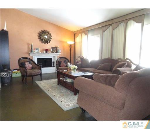 28 Bodnarik Road Edison, NJ 08837 - Photo 3 of 7 a living room with furniture and a fireplace