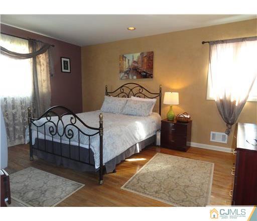28 Bodnarik Road Edison, NJ 08837 - Photo 6 of 7 a bedroom with a bed window and dresser