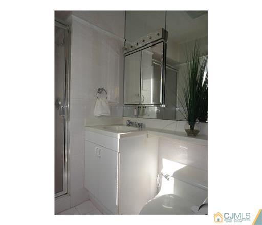 28 Bodnarik Road Edison, NJ 08837 - Photo 7 of 7 a bathroom with a sink and a mirror