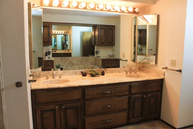 a bathroom with a double vanity sink and a mirror