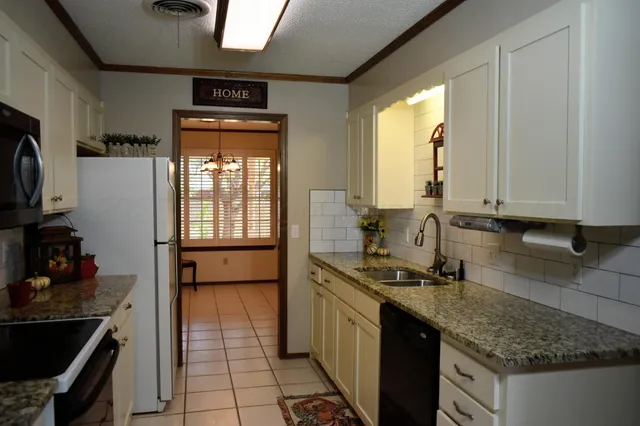 a kitchen with a sink stove and cabinets