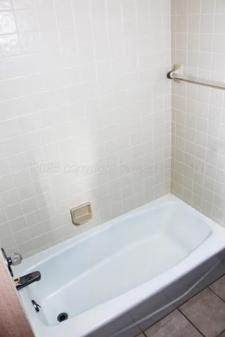 a view of an empty room with window and closet area