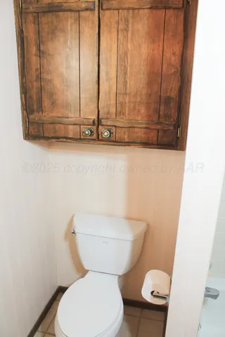 a backyard of a house with large trees and a barn