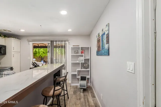 a kitchen with kitchen island granite countertop a sink a counter top space appliances and cabinets
