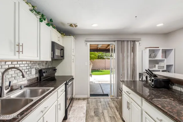 a kitchen with a sink stove and cabinets