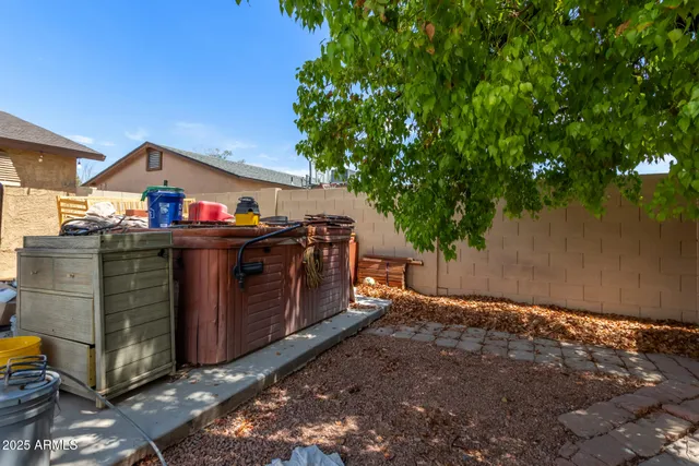a view of a house with a backyard porch and sitting area