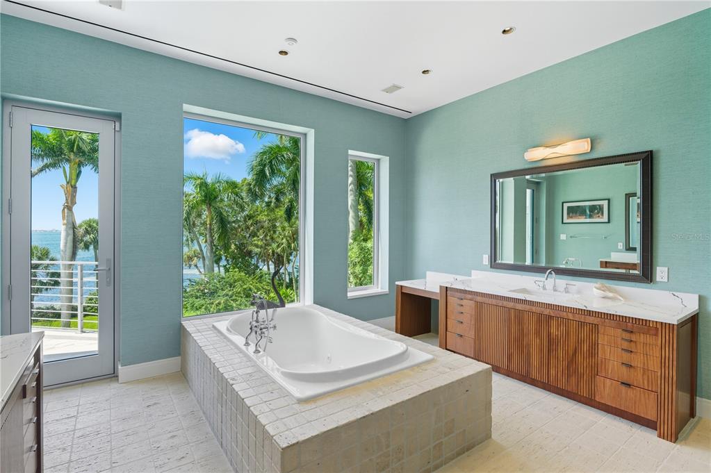 3315 Bay Shore Road Sarasota, FL 34234 - Photo 72 of 96 a spacious bathroom with a granite countertop tub sink and mirror