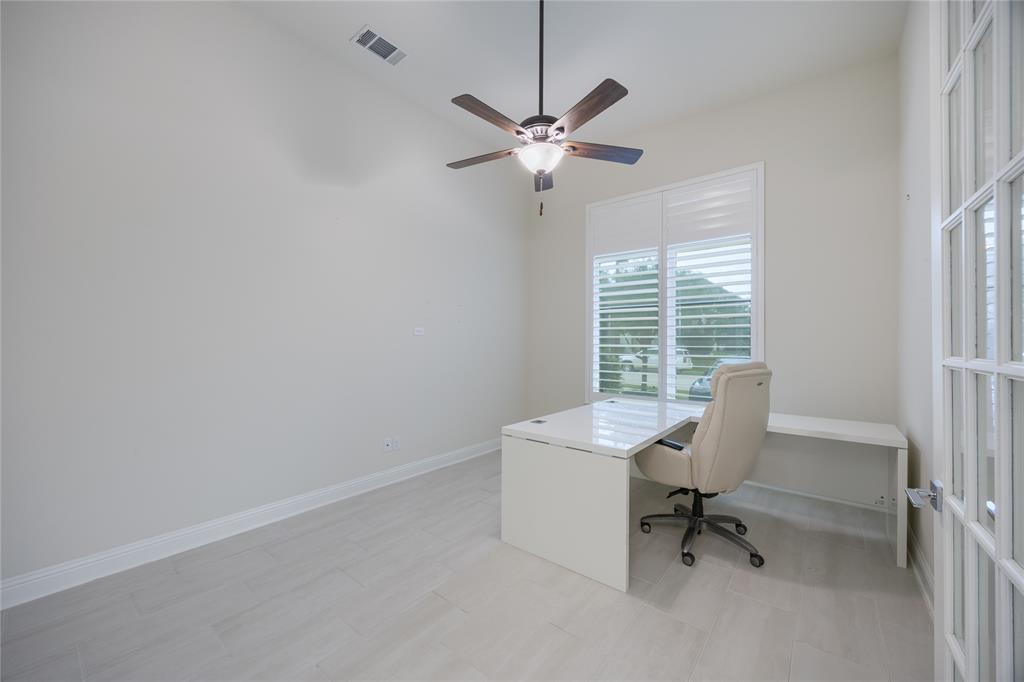 918 Sydney Lane Allen, TX 75013 - Photo 4 of 40 Well-lit room featuring light-colored flooring, a large window with blinds, and a ceiling fan with integrated lighting