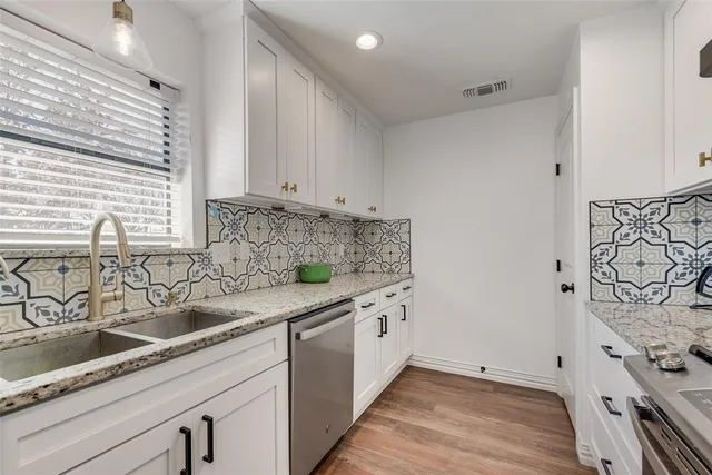 a kitchen with a sink and cabinets