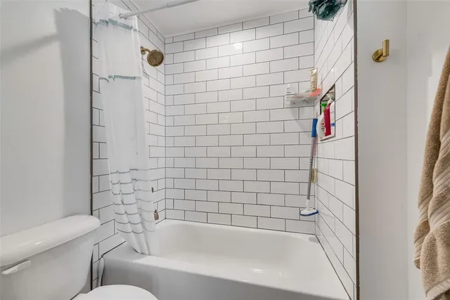 a bathroom with a bathtub and shower