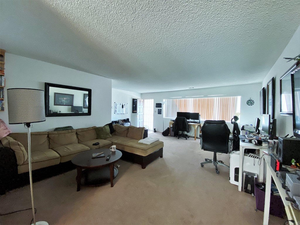 1121 Gardena Road Encinitas, CA 92024 - Photo 12 of 15 a living room with furniture and a flat screen tv