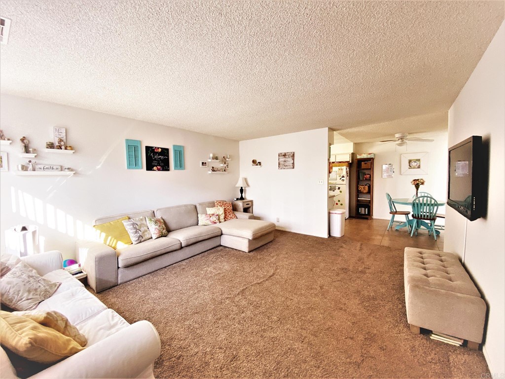 1121 Gardena Road Encinitas, CA 92024 - Photo 4 of 15 a living room with furniture and a flat screen tv