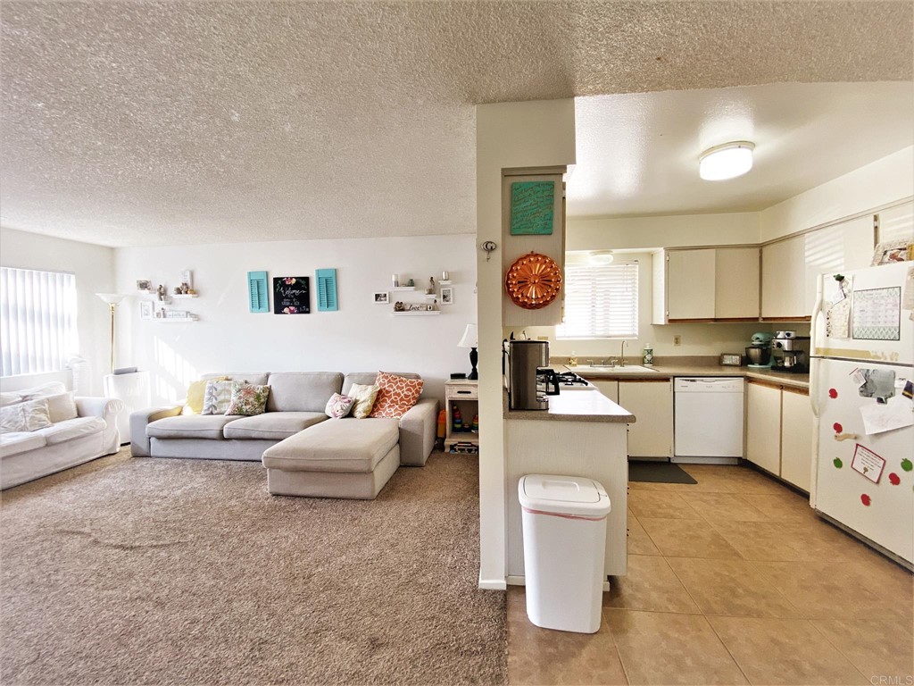 1121 Gardena Road Encinitas, CA 92024 - Photo 6 of 15 a living room with furniture and kitchen view