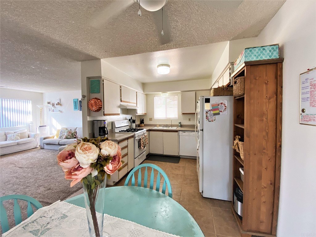 1121 Gardena Road Encinitas, CA 92024 - Photo 7 of 15 a kitchen with stainless steel appliances granite countertop a refrigerator and a sink