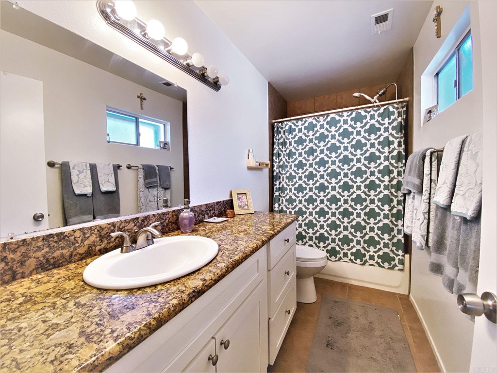 1121 Gardena Road Encinitas, CA 92024 - Photo 8 of 15 a bathroom with a granite countertop double vanity sink mirror and shower