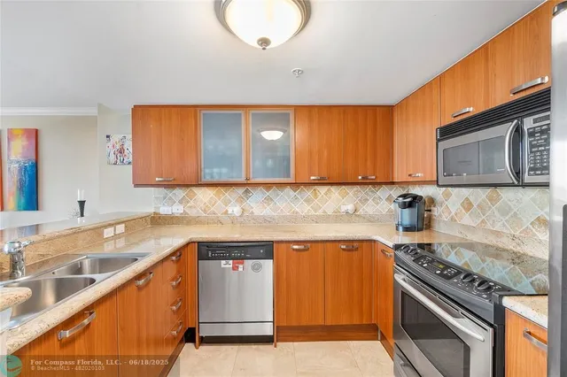 a kitchen with a sink stove top oven and cabinets