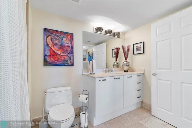 a bathroom with a toilet a sink and a mirror