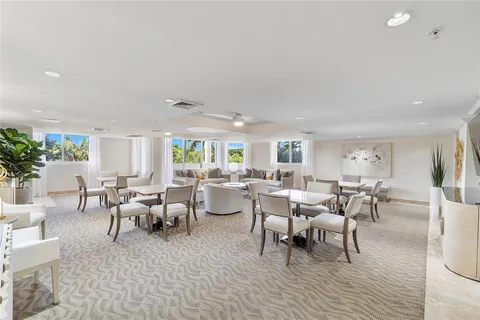 a living room with lots of furniture and a potted plant