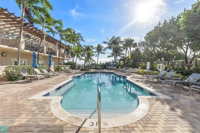 a swimming pool with outdoor seating and yard
