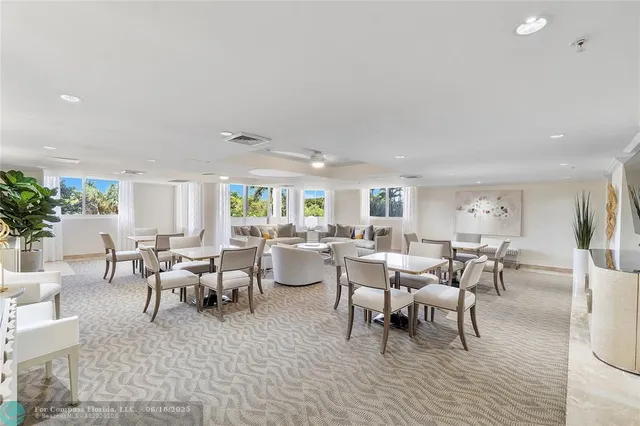 a living room with lots of furniture and a potted plant