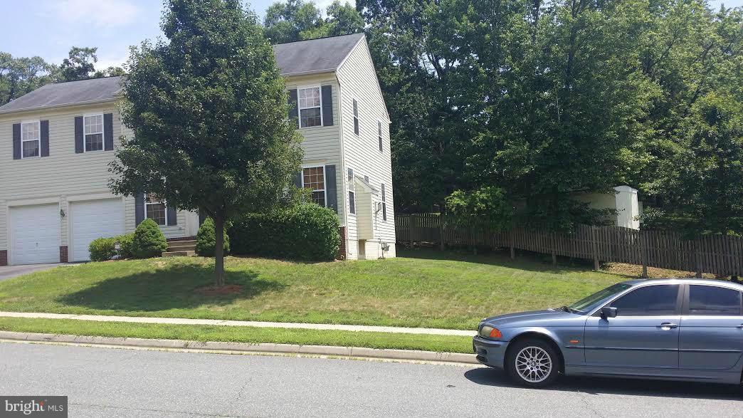 17619 Overlook Road Dumfries, VA 22026 - Photo 2 of 18 a view of a car parked in front of a house with a small yard