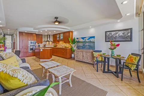 a living room with furniture a flat screen tv and a table