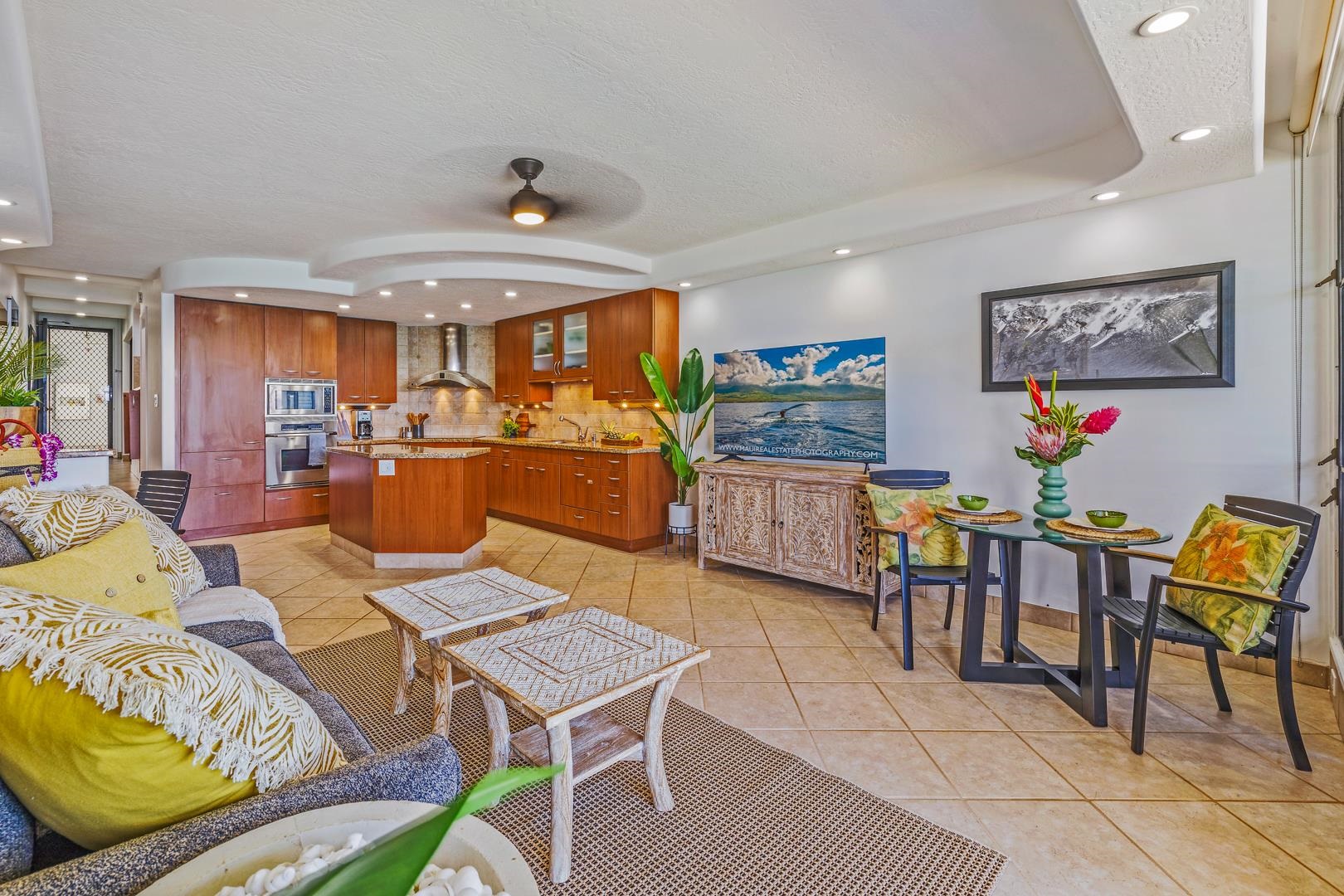 3875 Lower Honoapiilani Road, Unit B305 Lahaina, HI 96761 - Photo 8 of 35 a living room with furniture a flat screen tv and a table