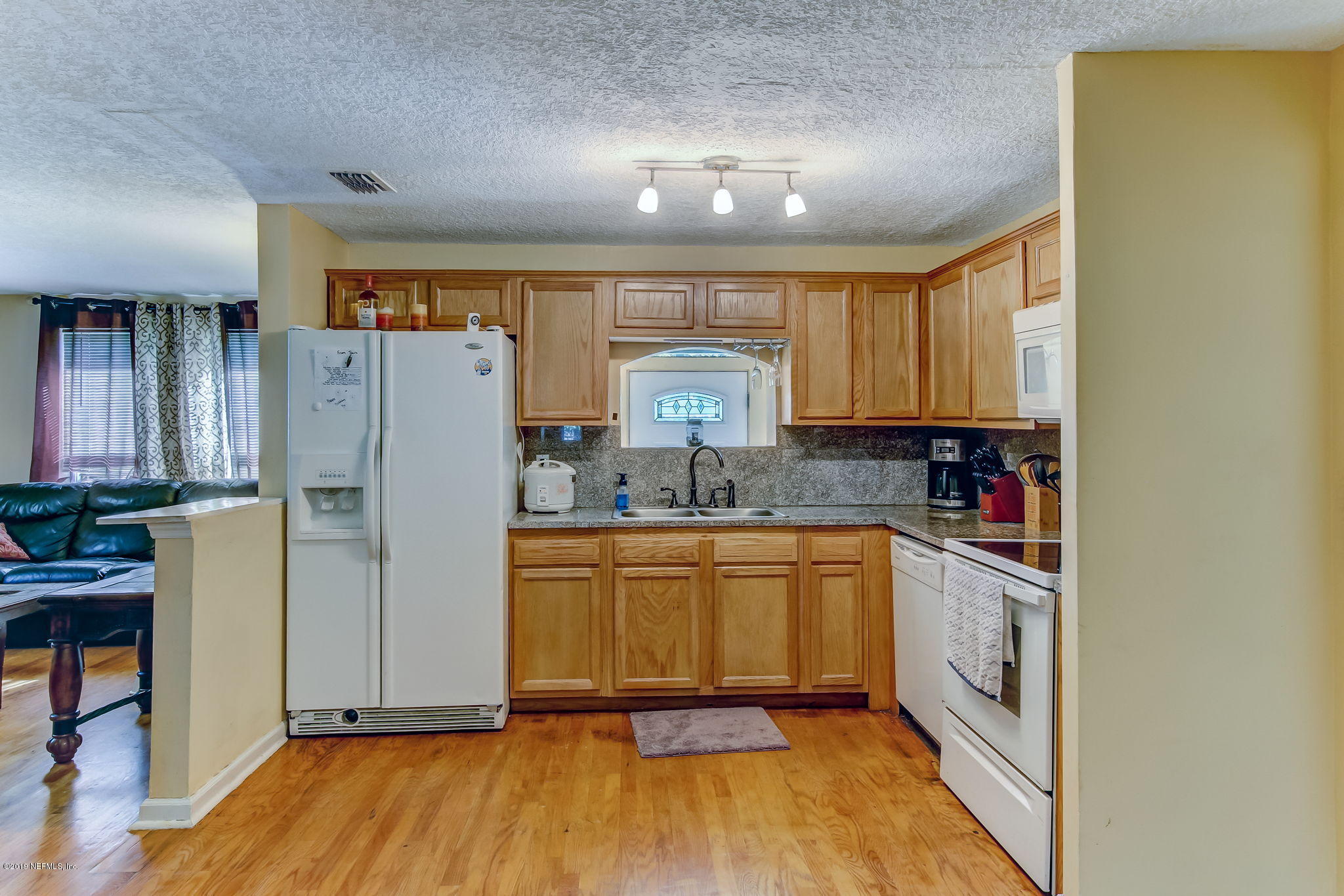 10321 Dobell Road Jacksonville, FL 32246 - Photo 12 of 34 a kitchen with stainless steel appliances a refrigerator sink and microwave
