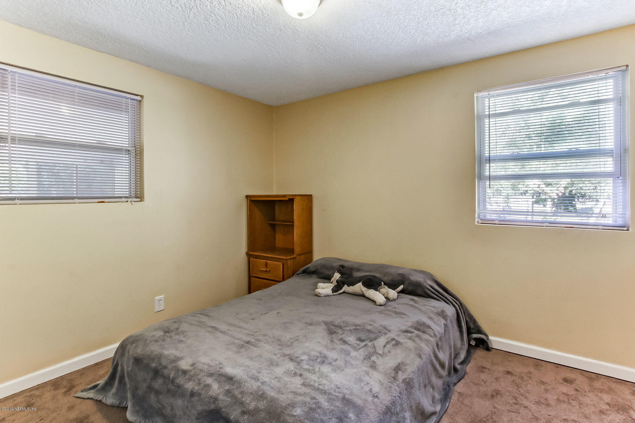 10321 Dobell Road Jacksonville, FL 32246 - Photo 22 of 34 a bedroom with a bed and a window
