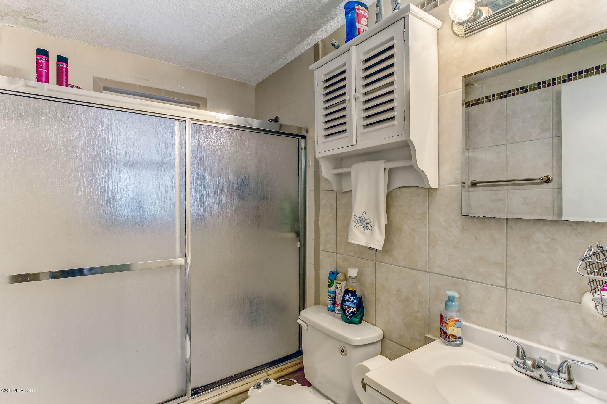 10321 Dobell Road Jacksonville, FL 32246 - Photo 24 of 34 a bathroom with a sink toilet and shower