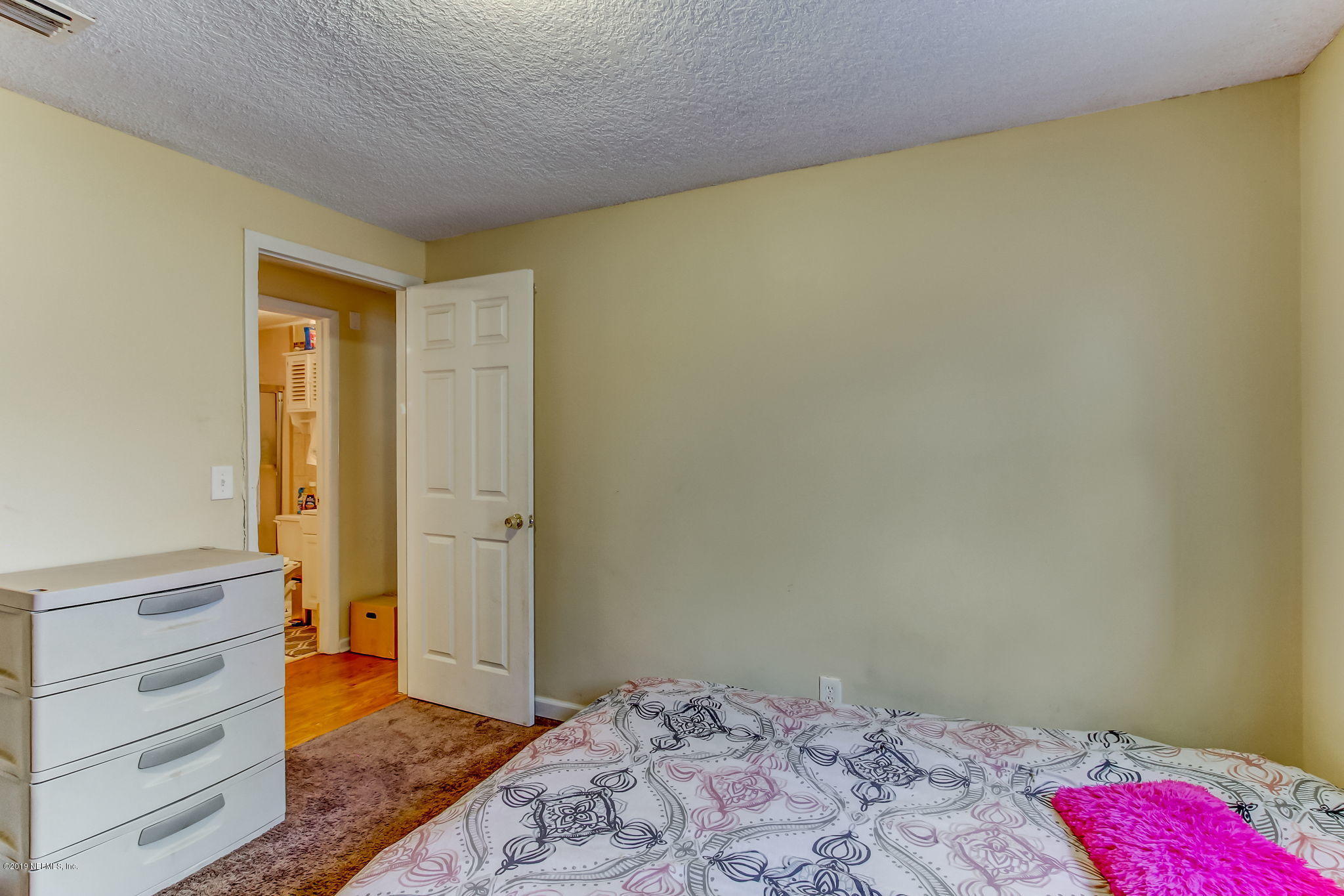 10321 Dobell Road Jacksonville, FL 32246 - Photo 26 of 34 a bedroom with a bed and wooden floor