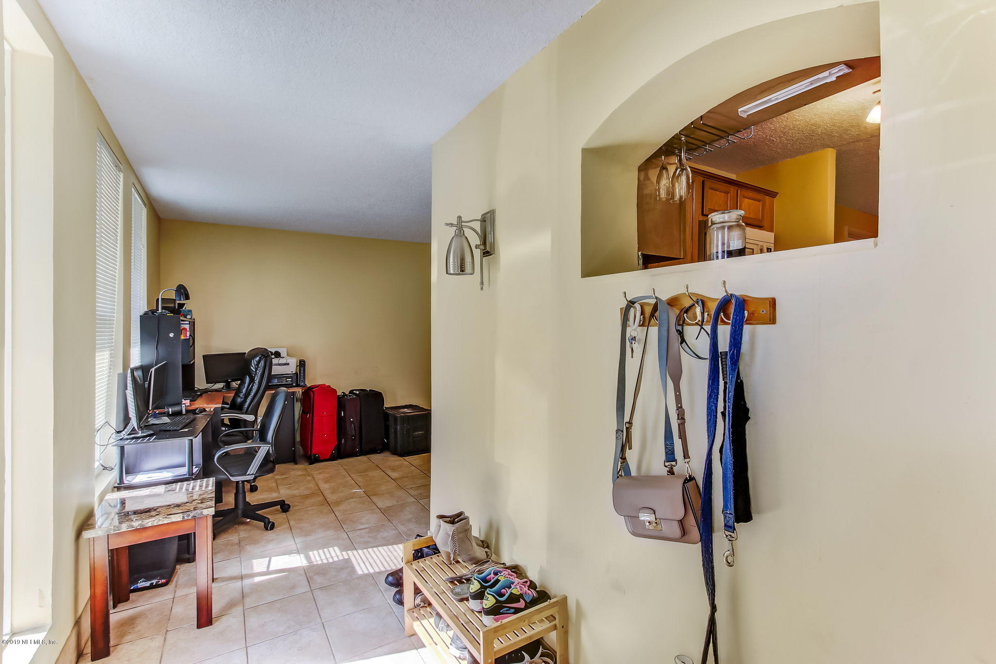 10321 Dobell Road Jacksonville, FL 32246 - Photo 6 of 34 a view of walk in closet with clothes and shoes