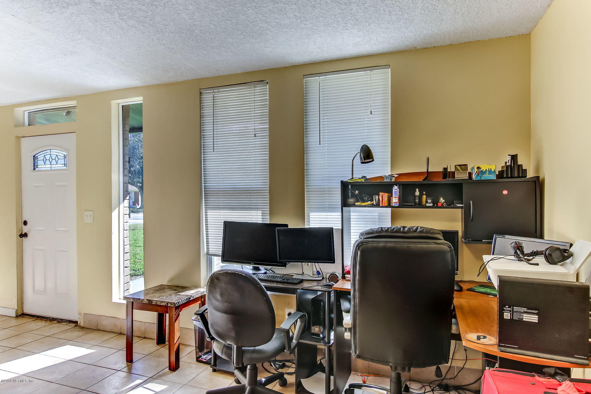 10321 Dobell Road Jacksonville, FL 32246 - Photo 8 of 34 a view of a workspace with furniture and a window