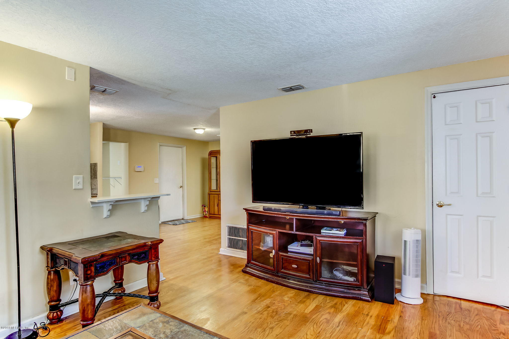 10321 Dobell Road Jacksonville, FL 32246 - Photo 9 of 34 a living room with furniture and a flat screen tv