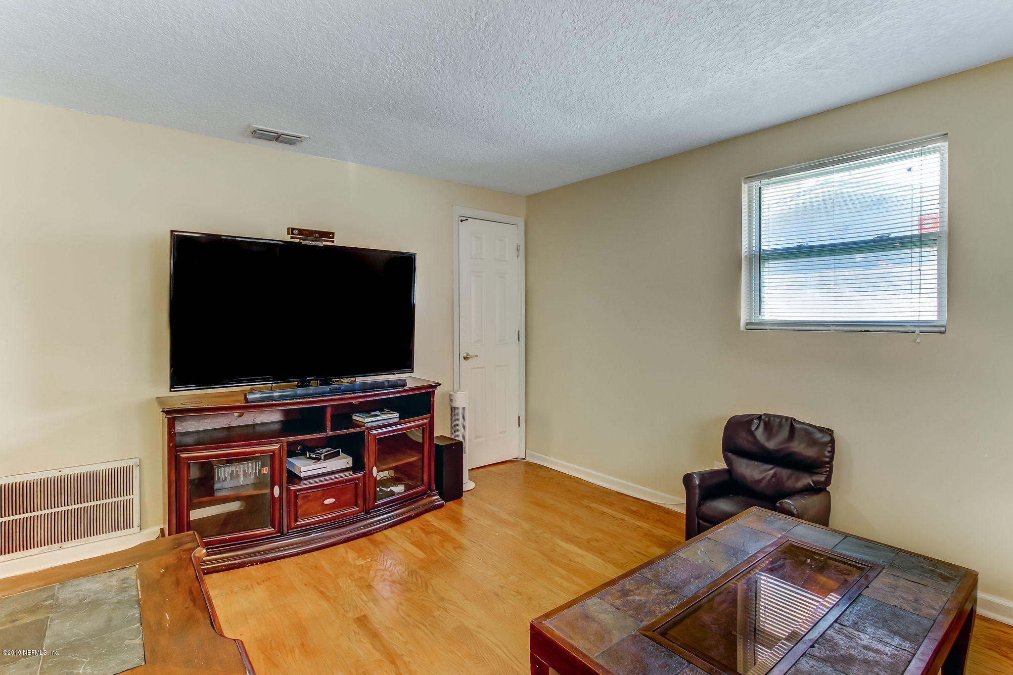 10321 Dobell Road Jacksonville, FL 32246 - Photo 10 of 34 a living room with furniture and a flat screen tv