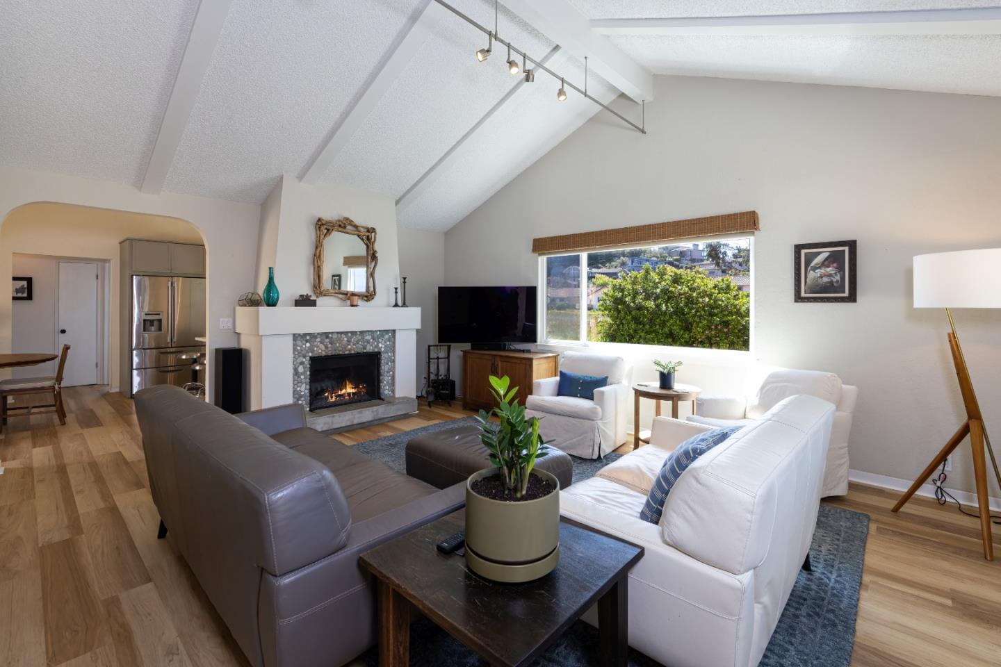 157 Oceanview Drive Watsonville, CA 95076 - Photo 6 of 25 a living room with furniture a fireplace and a flat screen tv