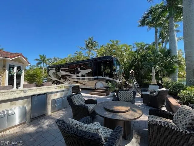 a backyard of a house with fire pit and outdoor seating