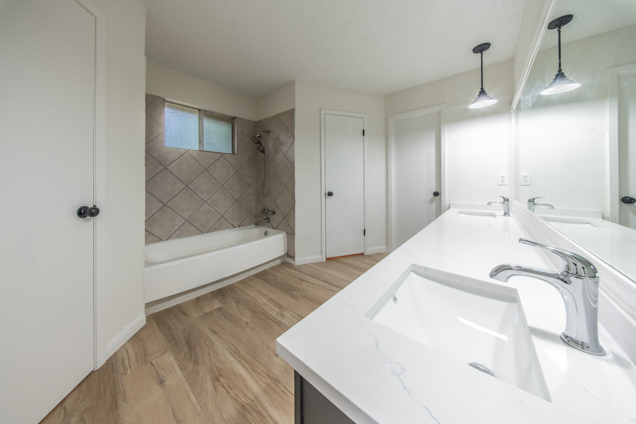 4504 Langtry Lane Austin, TX 78749 - Photo 15 of 24 Double vanity sinks and bright white countertops enhance this well-lit bathroom.